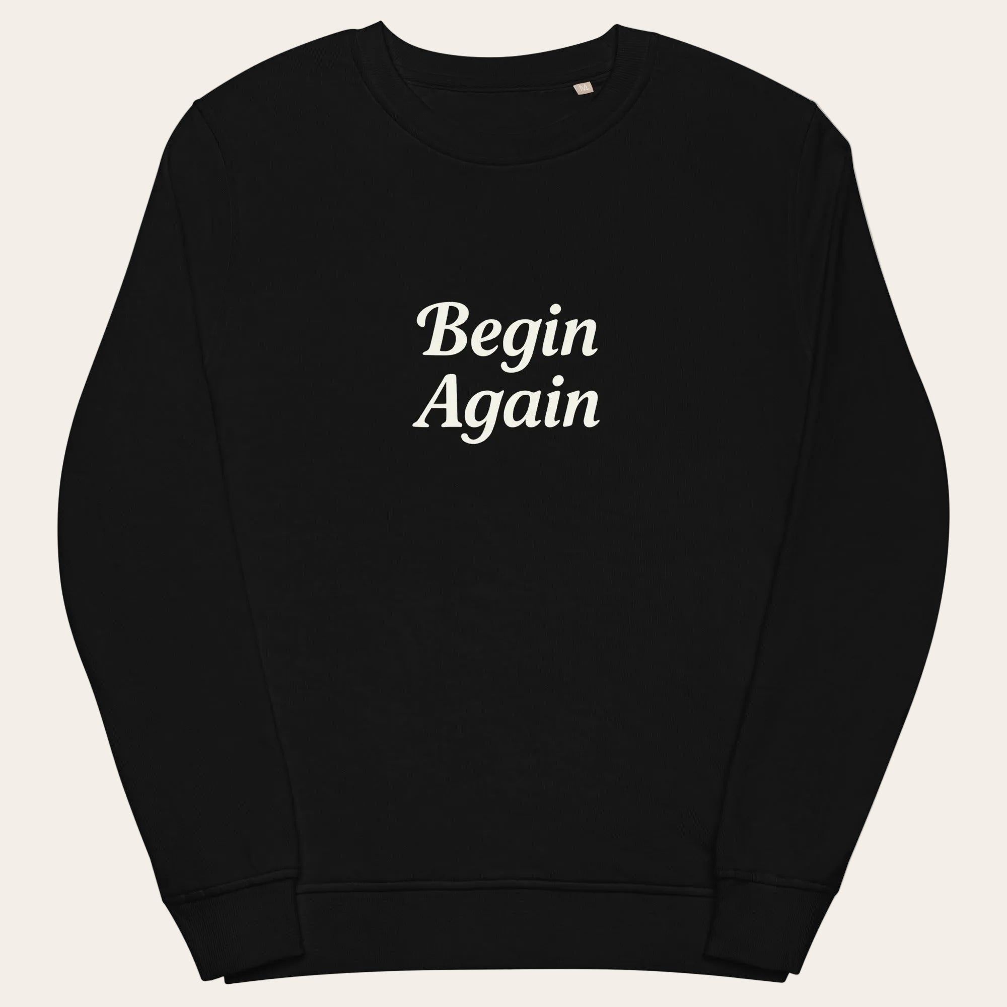 Black sweatshirt with 'Begin Again' text on a white background