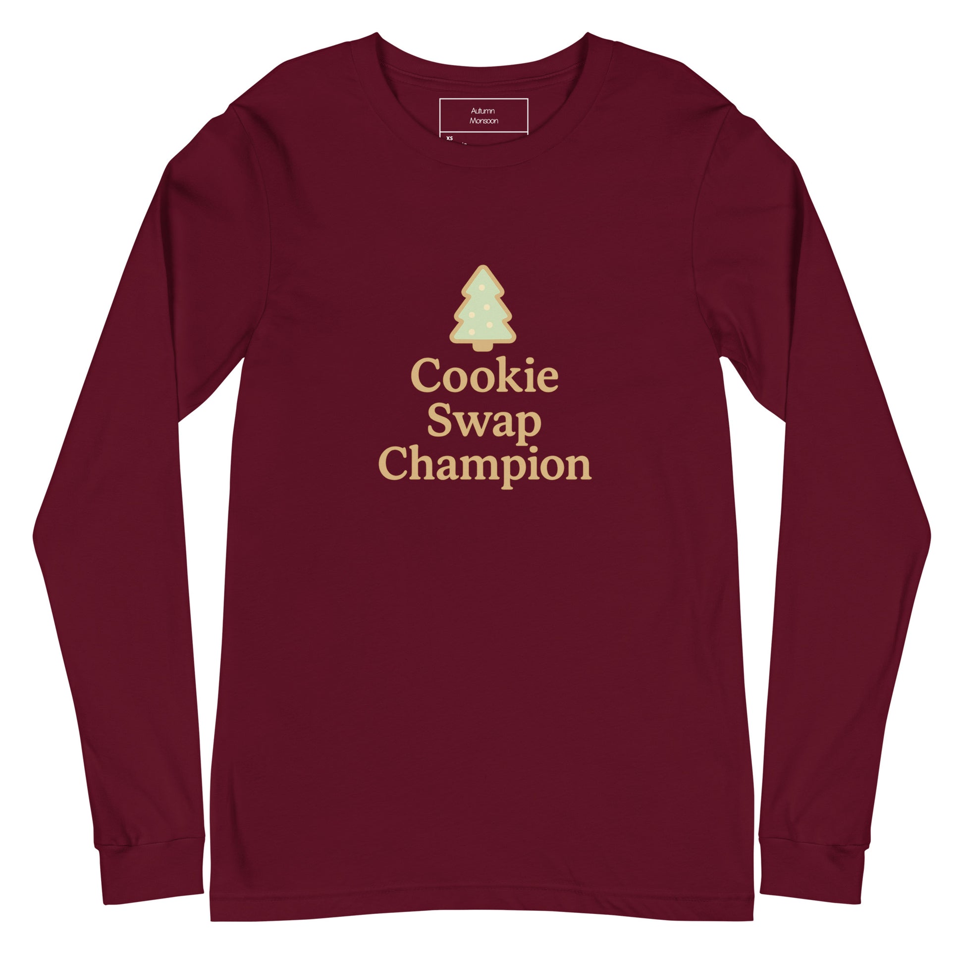 Maroon long-sleeve shirt with 'Cookie Swap Champion' text and tree graphic on a white background