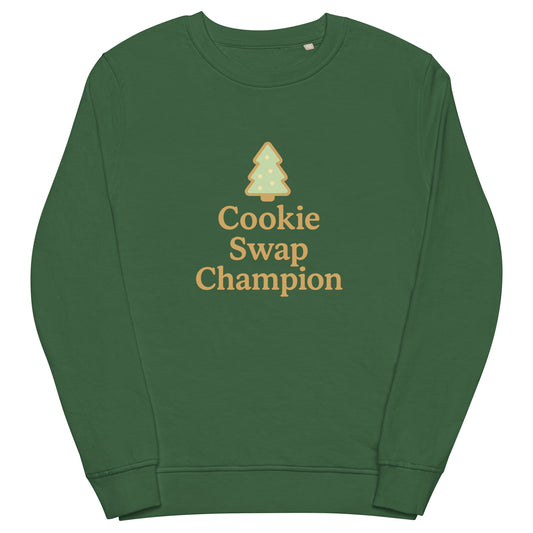 Green sweatshirt with 'Cookie Swap Champion' text and tree graphic on a white background