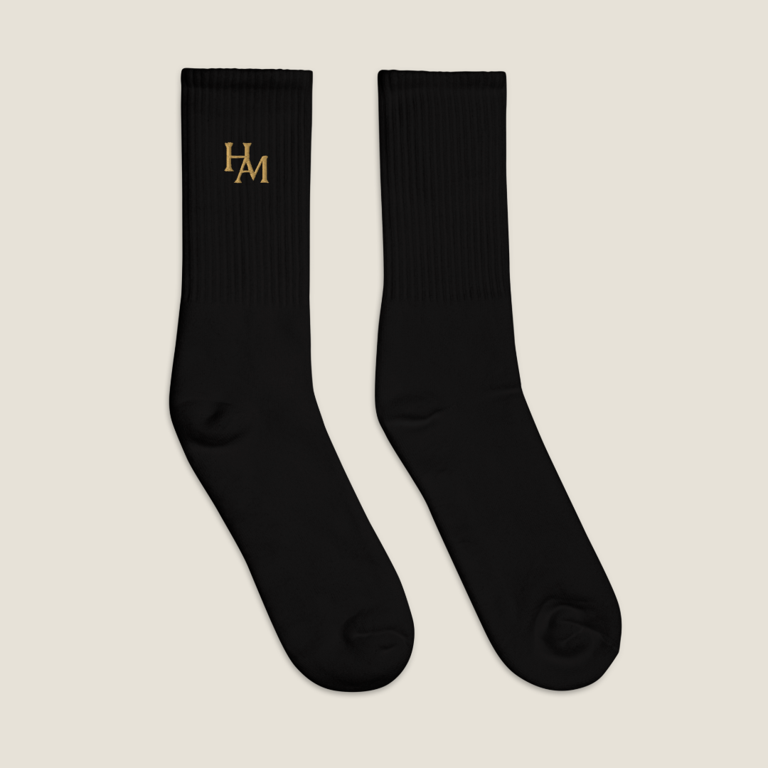 Pair of black socks with a logo on a white background