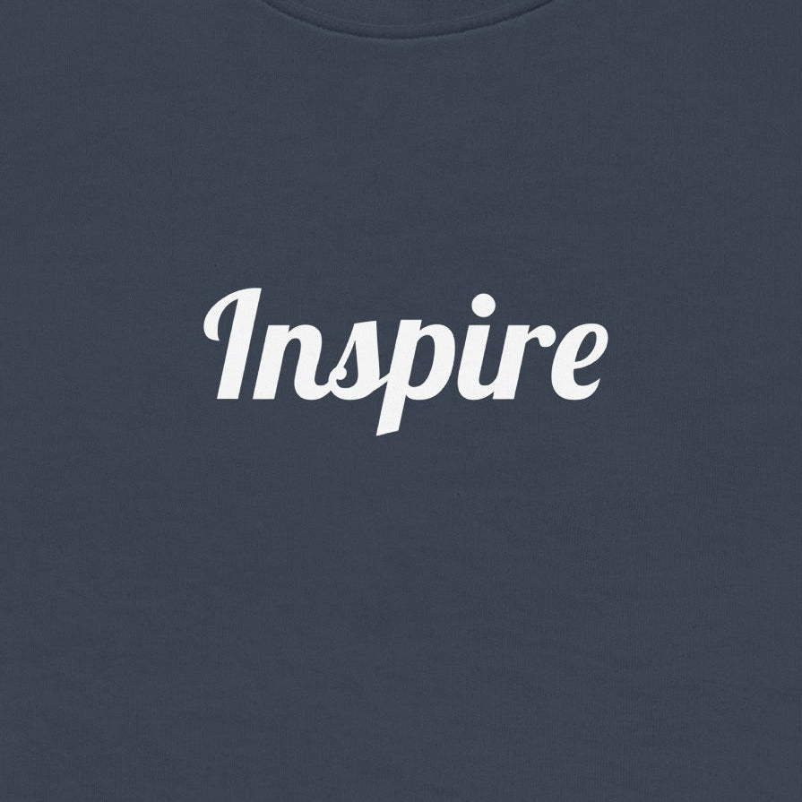 Navy blue sweatshirt with 'Inspire' text on a white background