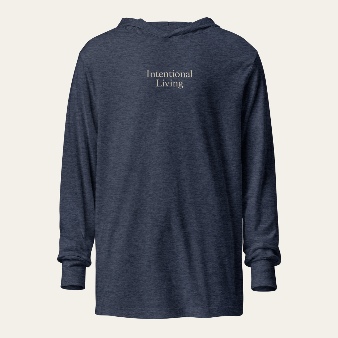 Heather navy long sleeve hooded tee with the saying Intentional Living on the chest.