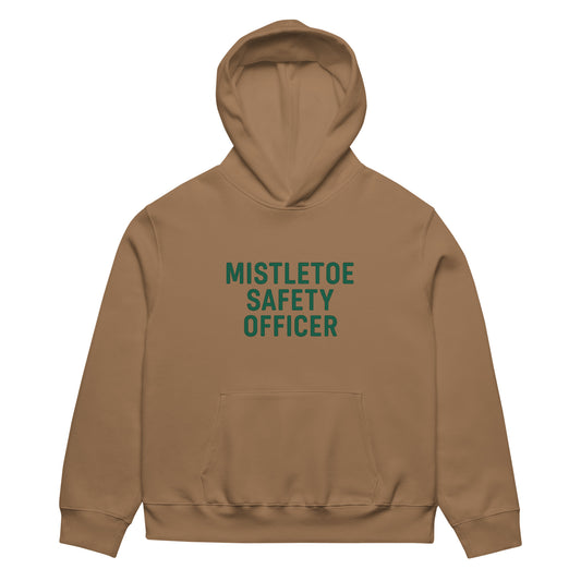 Brown hoodie with 'Mistletoe Safety Officer' text on a white background