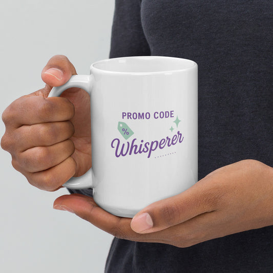 Person holding a white mug with 'Promo Code Whisperer' text on a plain background
