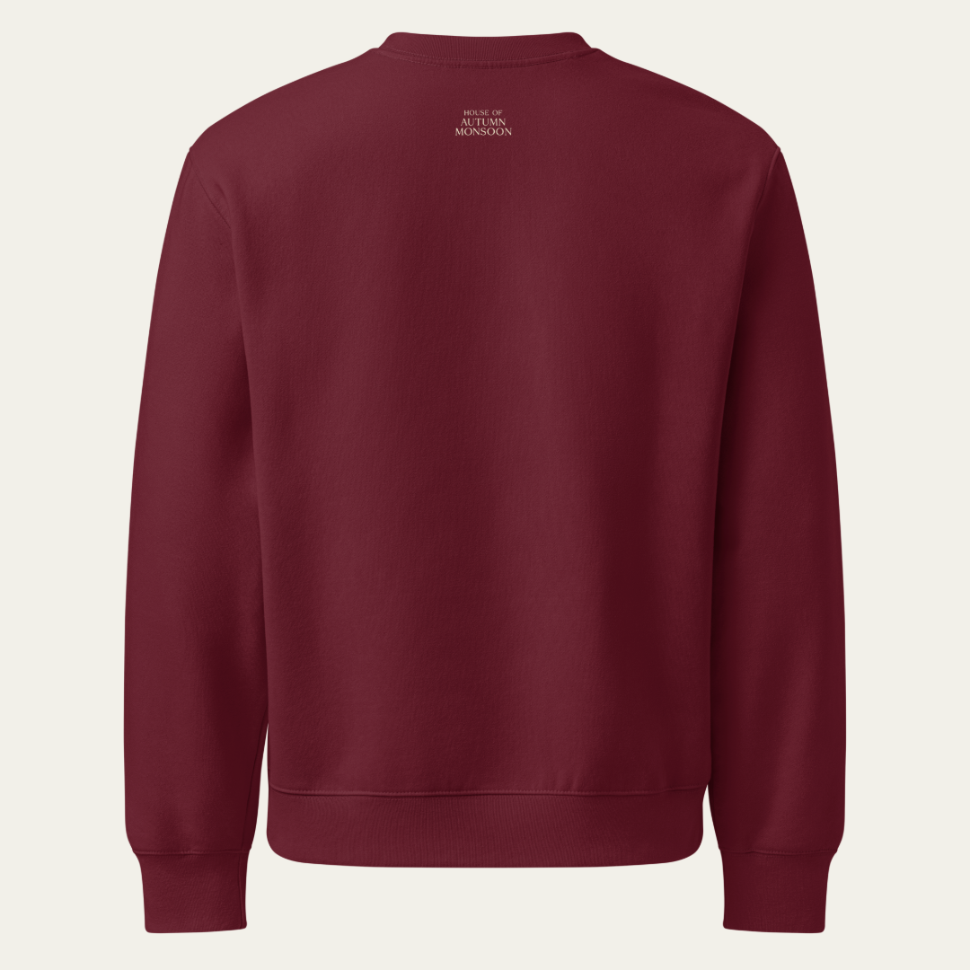 Back of a maroon sweatshirt with the House of Autumn Monsoon logo on the upper center back