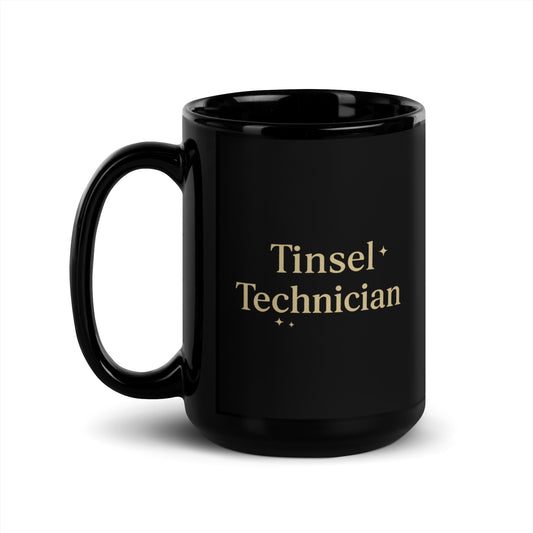 Black mug with 'Tinsel Technician' text in gold on a white background