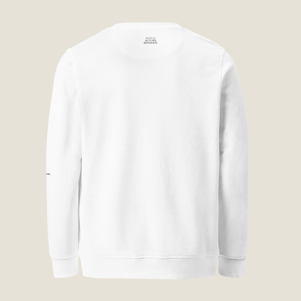 A plain white crewneck sweatshirt shown from the back, featuring a small black text print inside the collar that reads 'HOUSE OF AUTUMN MONSOON' and small black text on the left sleeve, set against a solid light beige background.