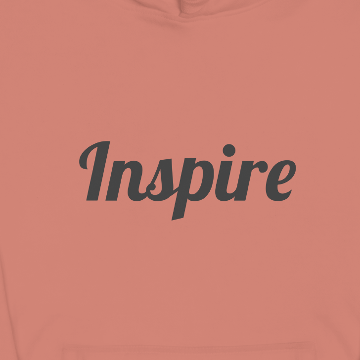 Coral hoodie with 'Inspire' text on a white background