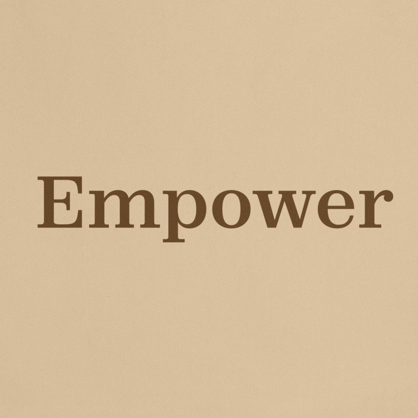 Beige tote bag with 'Empower' text on a white background