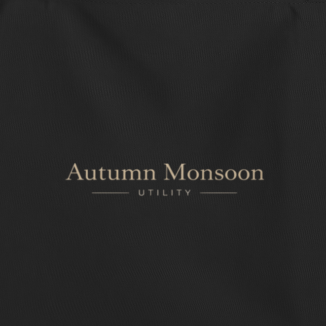Black tote bag with 'Autumn Monsoon' branding on a white background