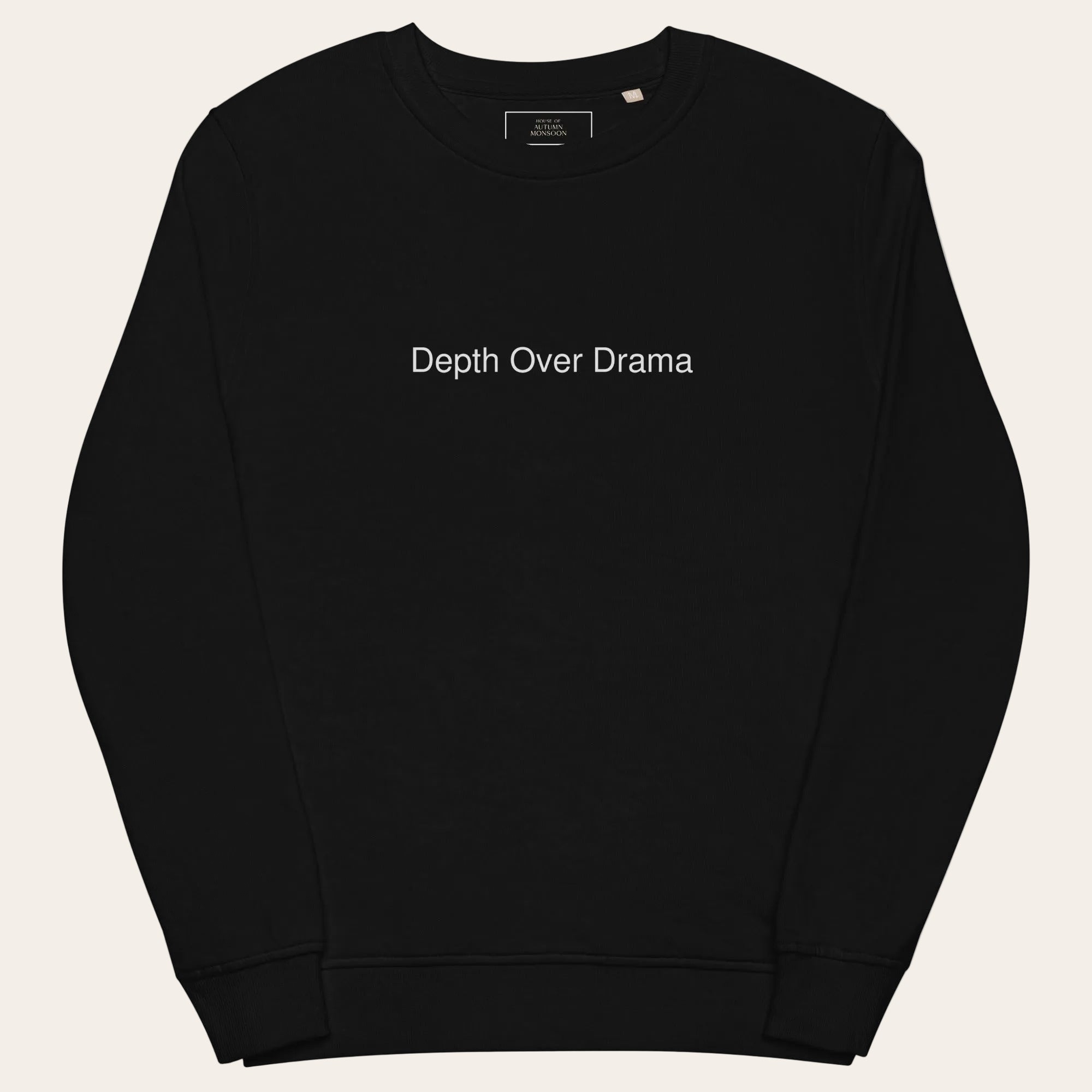 Black sweatshirt with 'Depth Over Drama' text on a white background