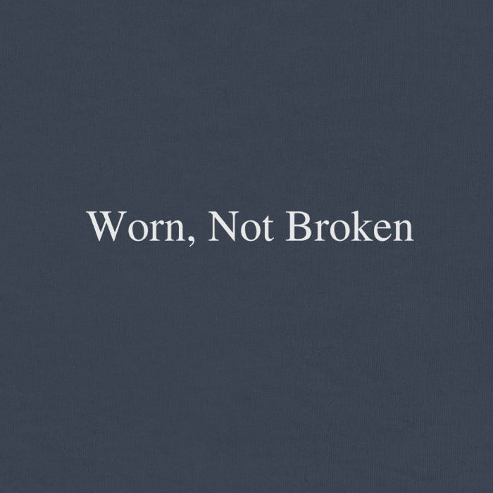 Navy blue sweatshirt with 'Worn, Not Broken' text on a white background