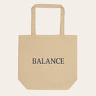 Beige tote bag with 'BALANCE' text on a white background