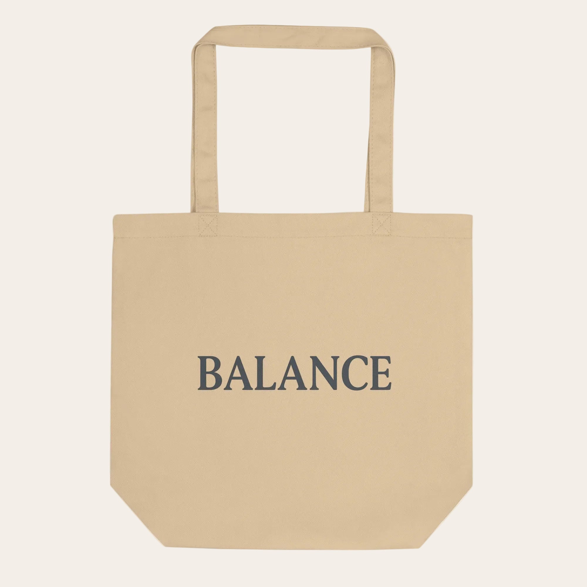 Beige tote bag with 'BALANCE' text on a white background