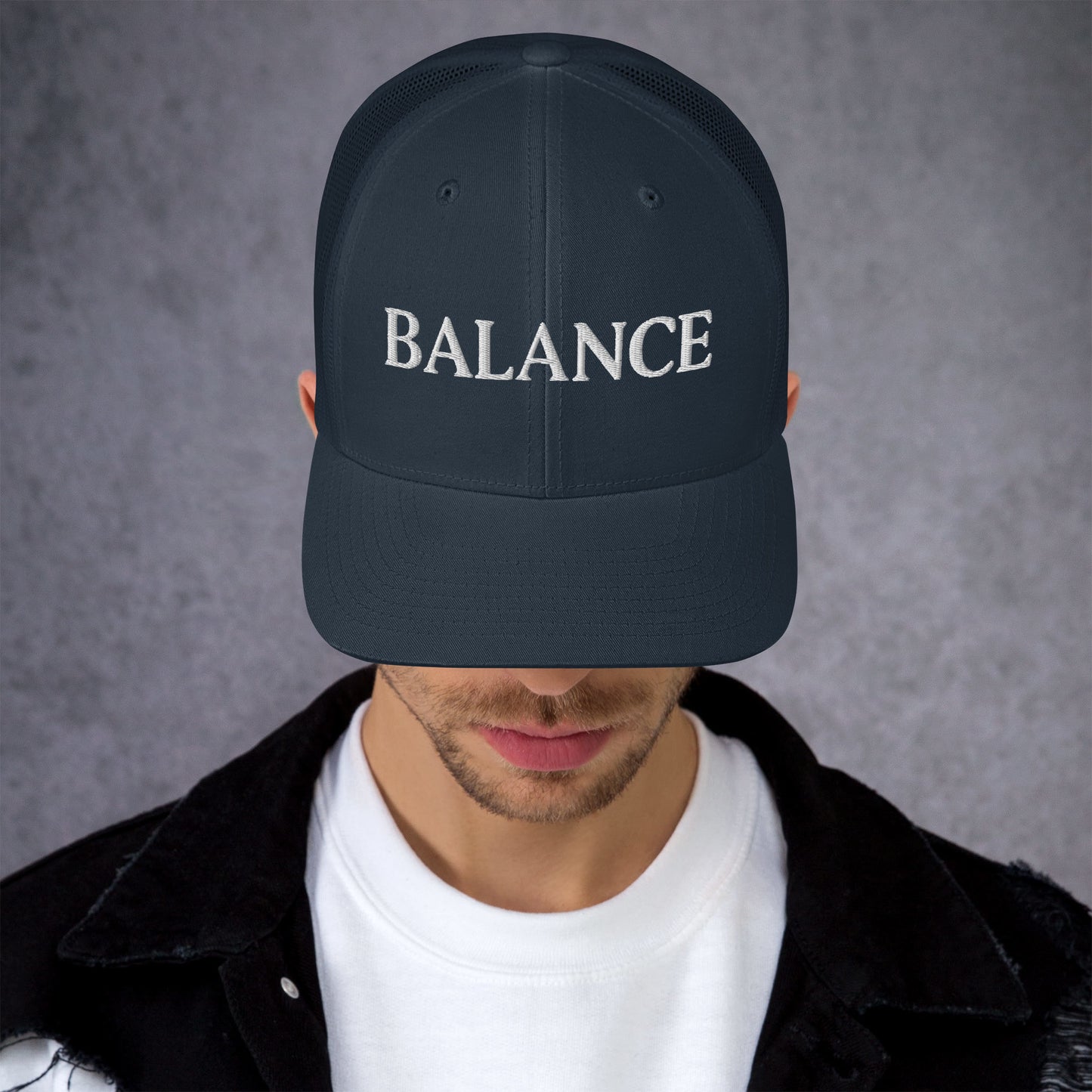 Person wearing a black cap with 'BALANCE' text on a gray background