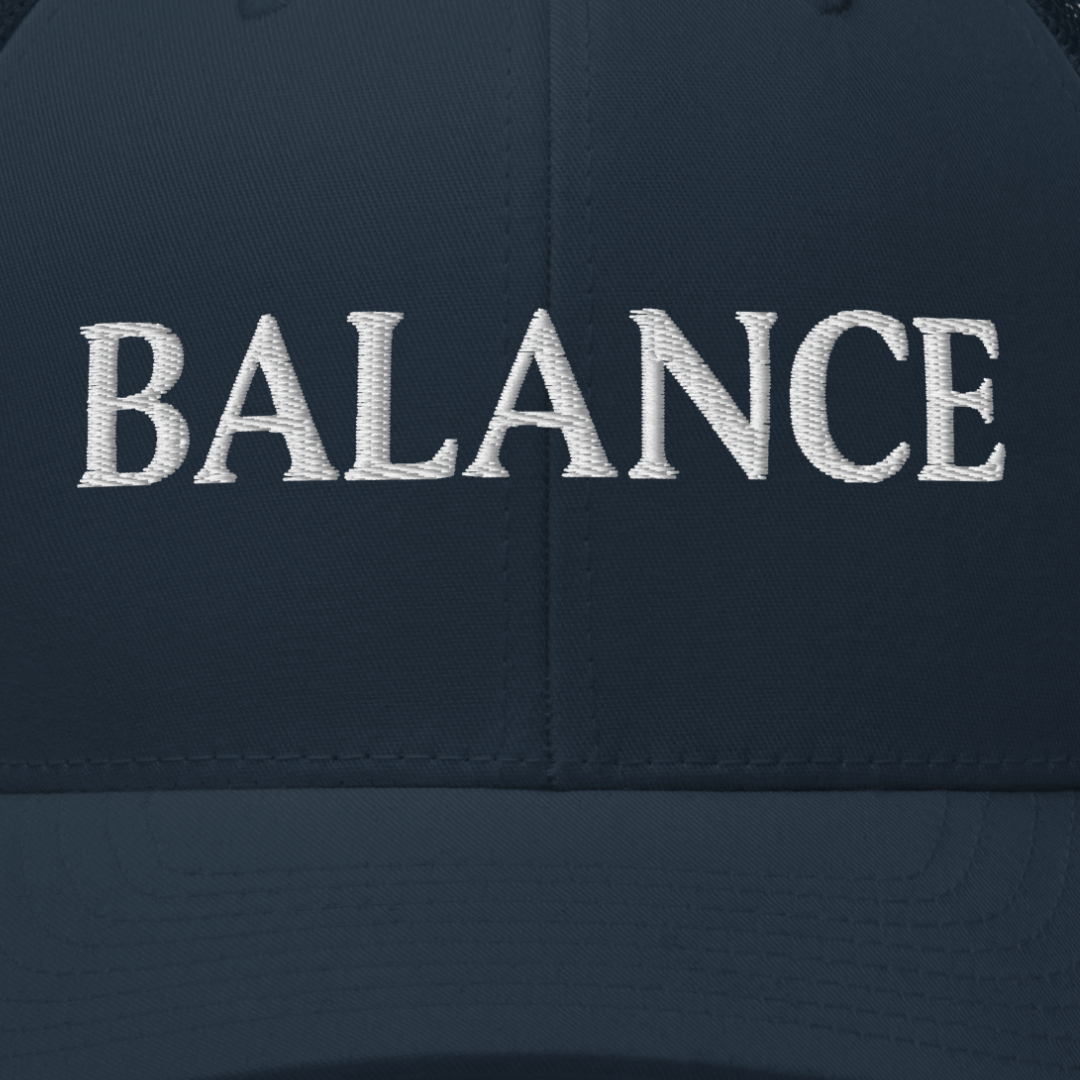 Navy blue cap with 'BALANCE' embroidered in white on a dark background