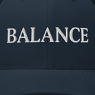 Navy blue cap with 'BALANCE' embroidered in white on a dark background