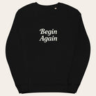Black sweatshirt with 'Begin Again' text on a white background