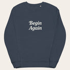 Navy blue sweatshirt with 'Begin Again' text on a white background