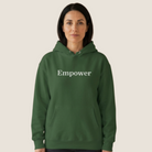 Woman wearing a green hoodie with "Empower" on the chest.
