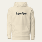A cream-colored pullover hoodie with the word 'Evolve' printed in black script across the chest, displayed on a light off-white background.