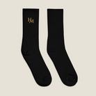 Pair of black socks with a logo on a white background