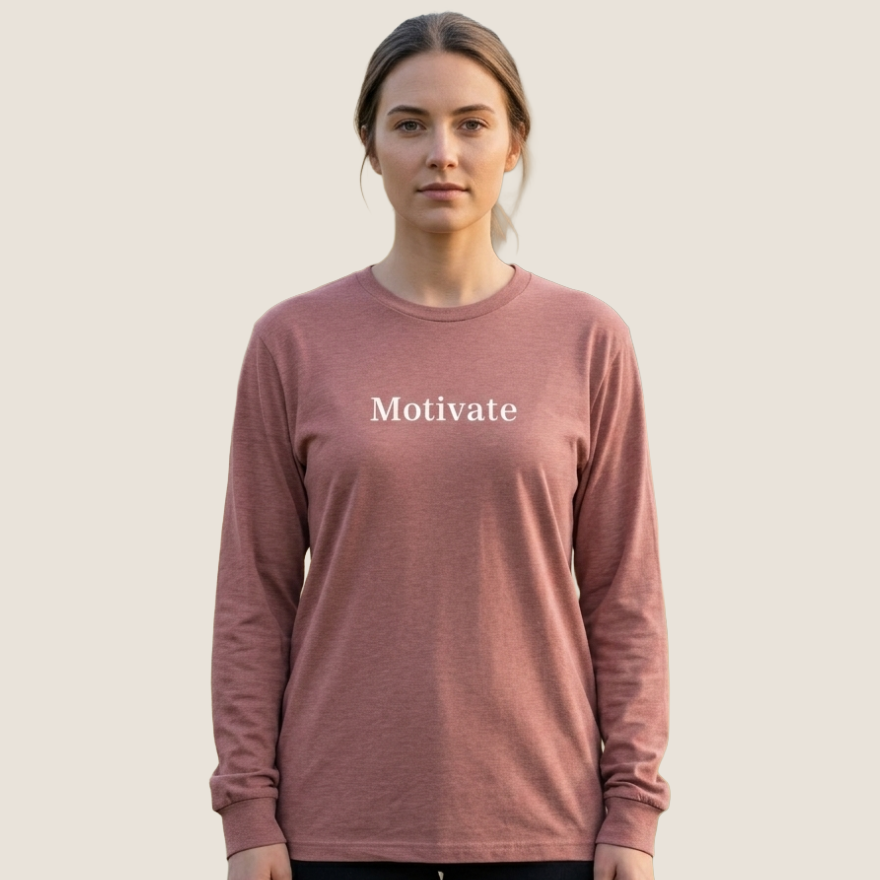 Woman wearing a mauve long sleeve tee with "Motivate" across the chest.