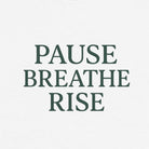 White sweatshirt with 'PAUSE BREATHE RISE' text on a white background