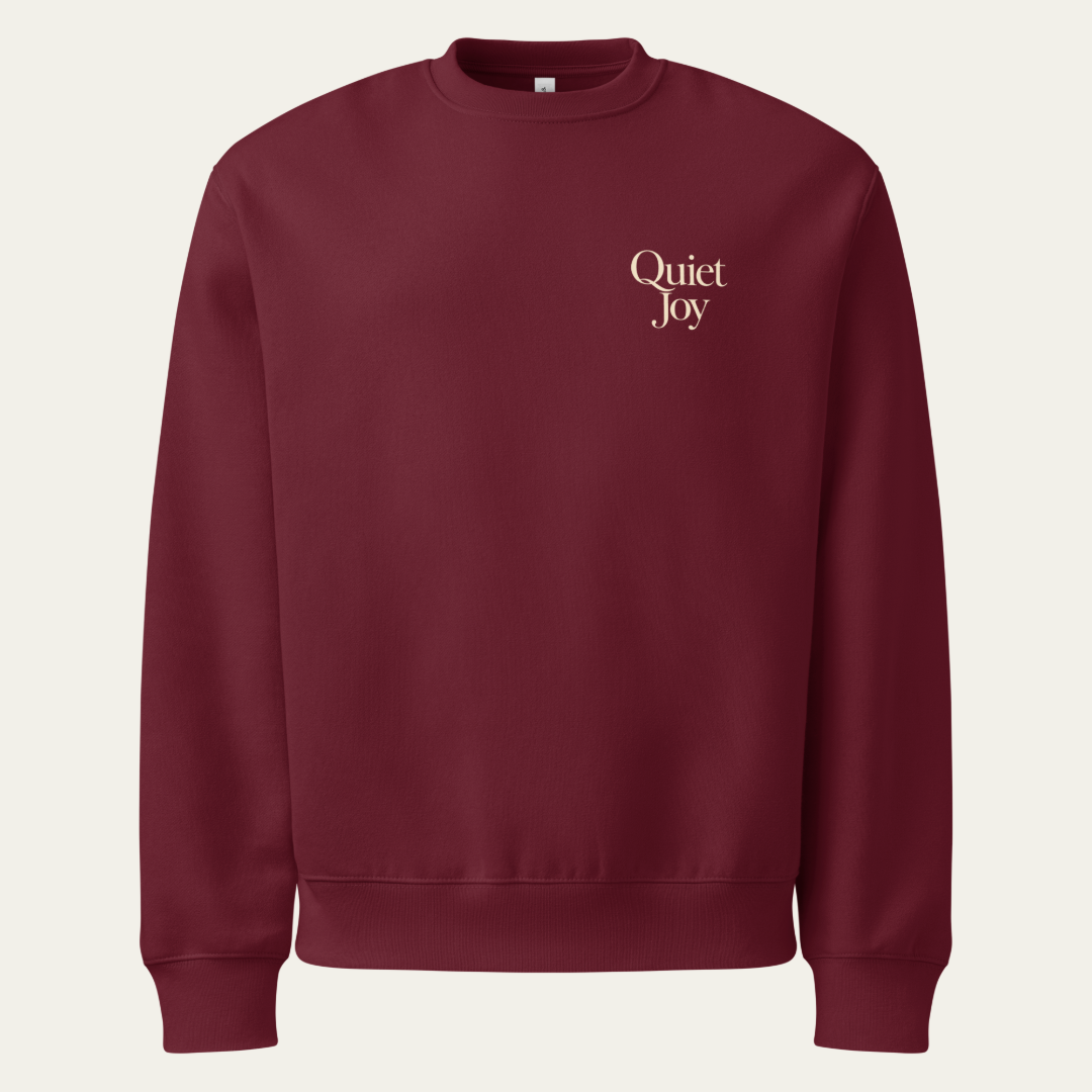 Maroon sweatshirt with Quiet Joy on the upper left chest