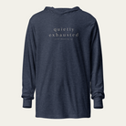 Navy blue hooded long sleeve tee with "quietly exhausted" and "still showing up" on the chest