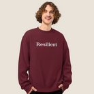 Mean wearing a maroon sweatshirt with "Resilient" text across chest.