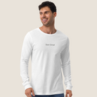 Man wearing white long sleeve tee with "Start Small" on the chest
