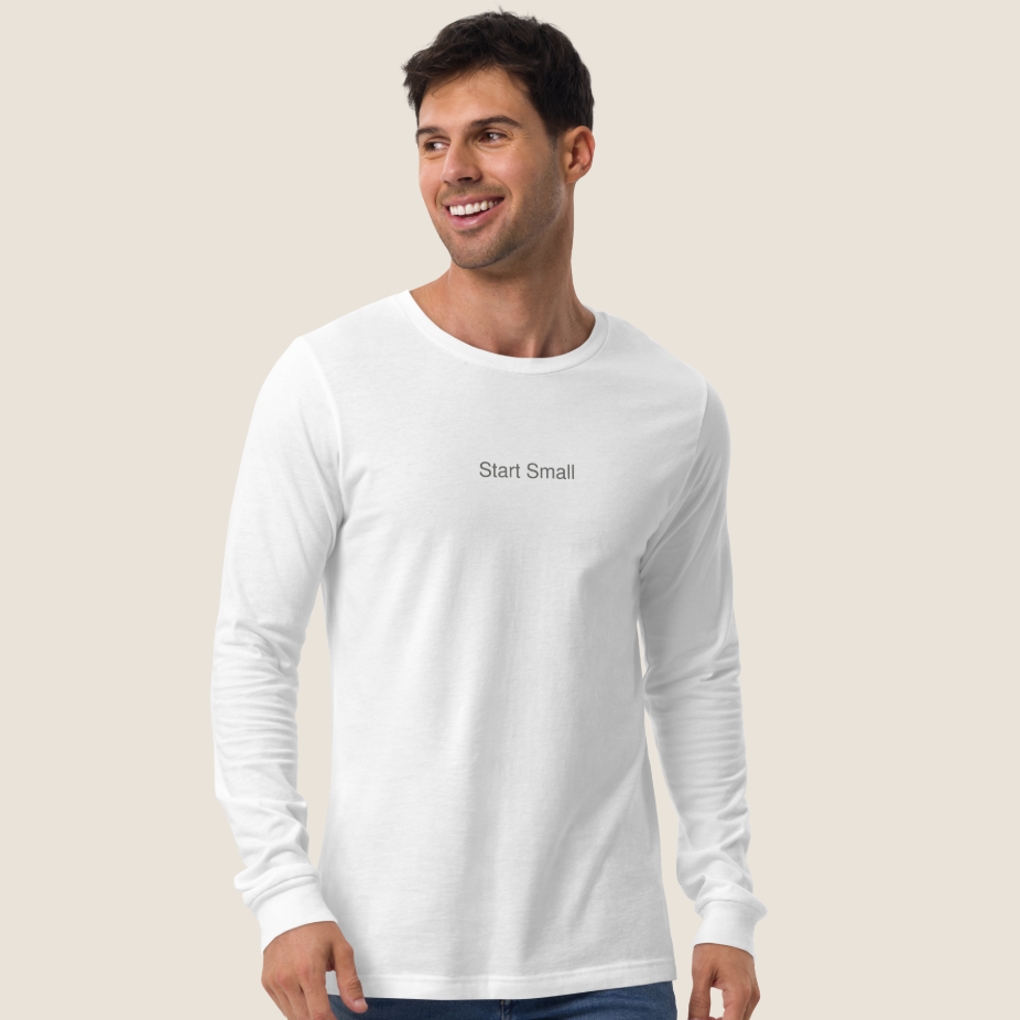Man wearing white long sleeve tee with "Start Small" on the chest