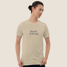 Man wearing a Steady & Strong khaki t-shirt