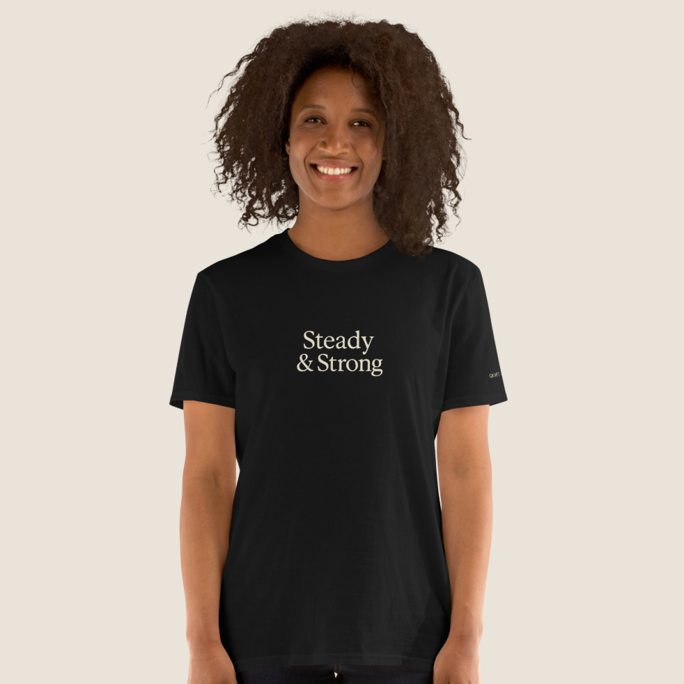 Woman wearing a black t-shirt with "Steady & Strong" across the chest