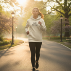 Person running in a park wearing a 'Still Rising' hoodie