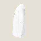 A white long-sleeve crewneck sweatshirt shown in a side profile view against a solid light beige background. The sweatshirt features small black text graphics on the chest and sleeve.