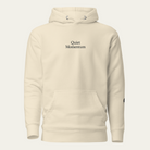 An off-white pullover hoodie with 'Quiet Momentum' printed in black serif text on the chest, displayed on a clean, light off-white background.