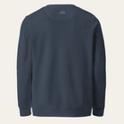 A dark navy blue crewneck sweatshirt shown from the back, photographed flat against a light off-white background.