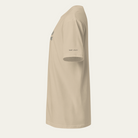 Side view of a khaki tee. "QUIET UTILITY" in printed at the bottom of the sleeve