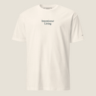 Front of cream t-shirt. Intentional Living printed on chest area with text on left sleeve.