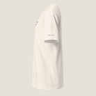 Side view of a cream t-shirt. "QUIET UTILITY" on bottom of left sleeve.