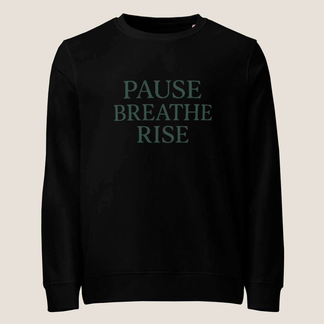 Black sweatshirt with 'PAUSE BREATHE RISE' text in white on a white background
