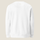 A plain white crewneck sweatshirt shown from the back, photographed flat against a light beige background.