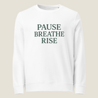 White sweatshirt with "PAUSE BREATHE RISE" on the front