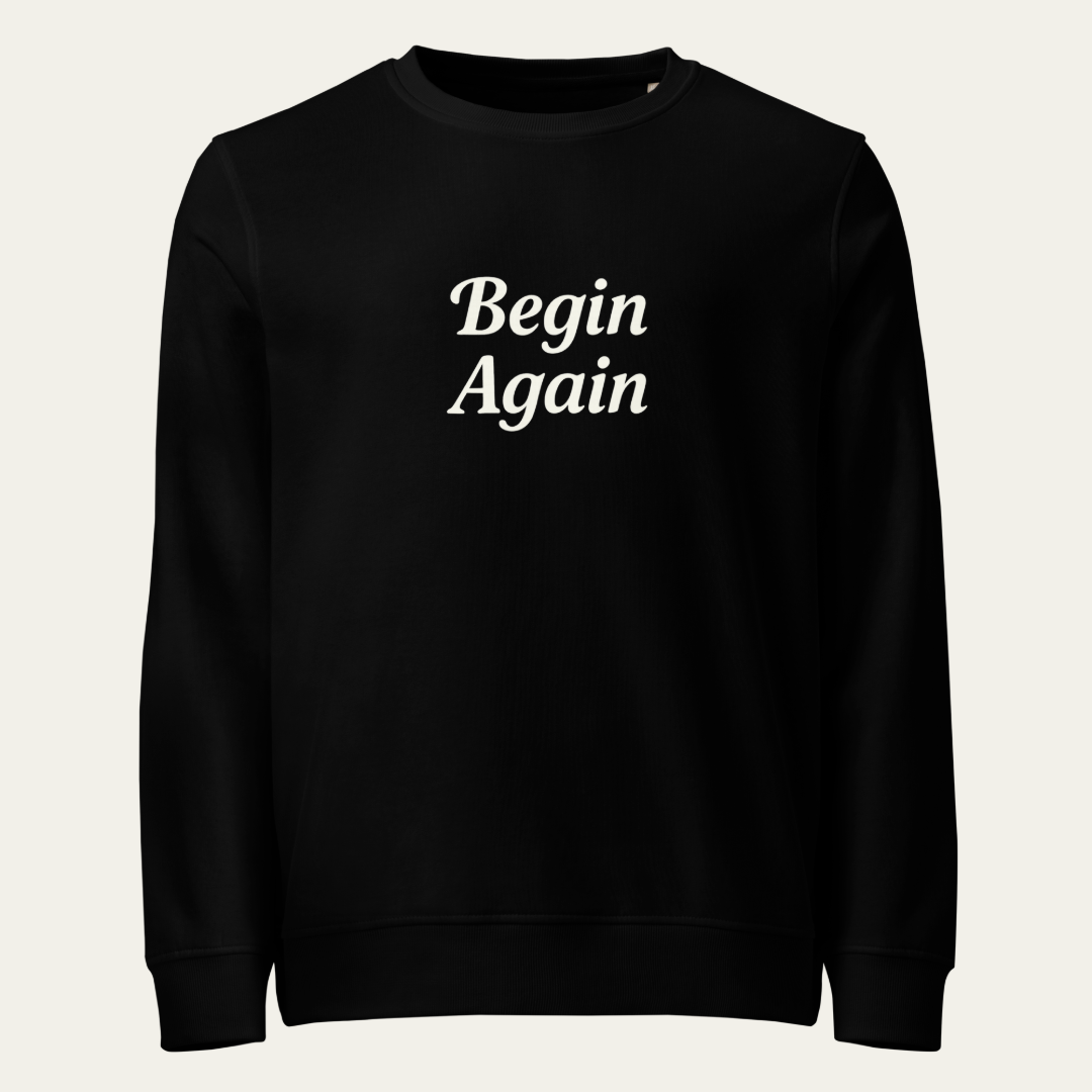 Black sweatshirt with "Begin Again" on the front.