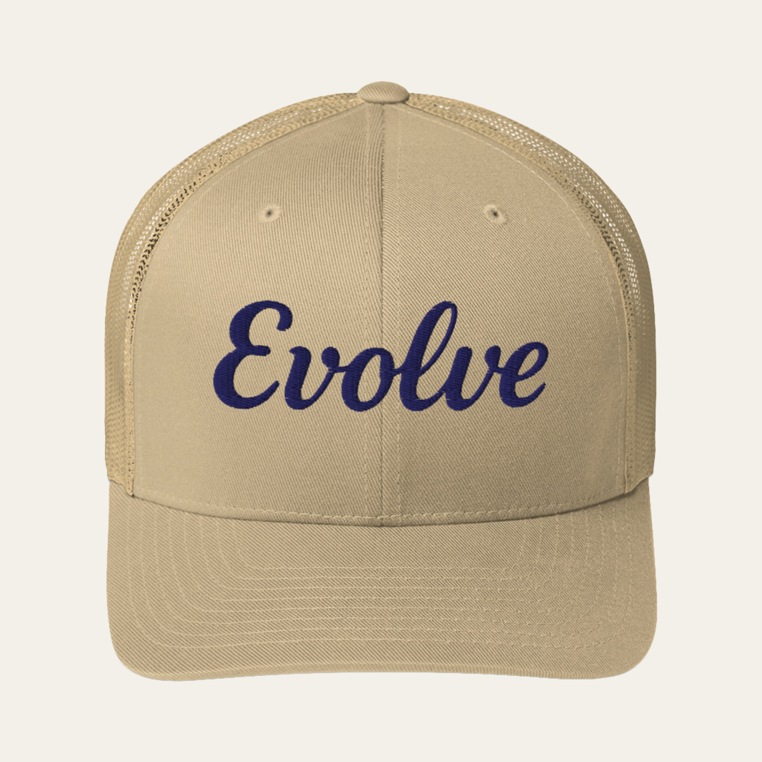 A beige trucker-style cap with dark navy blue embroidered script text reading 'Evolve' on the front, shown against a light off-white background.