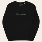 Black sweatshirt with 'Worn, Not Broken' text on a white background