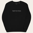 Black sweatshirt with 'Depth Over Drama' text on a white background