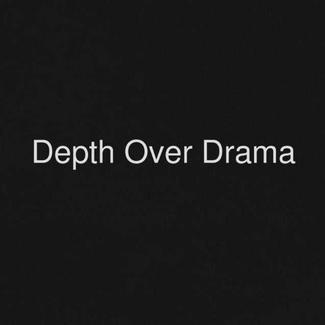 Black sweatshirt with 'Depth Over Drama' text on a white background
